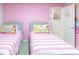 A colorful bedroom with twin beds and playful princess decorations, perfect for  at 7352 Oakmoss Loop, Davenport, FL 33837