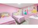 A bright bedroom with twin beds and cheerful princess wall art creates a magical space at 7352 Oakmoss Loop, Davenport, FL 33837