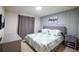 Comfortable bedroom with blue accent wall, luxurious bedding and modern decor at 7352 Oakmoss Loop, Davenport, FL 33837