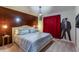 Bedroom with wooden accent wall and a comfortable bed at 7352 Oakmoss Loop, Davenport, FL 33837