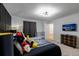 Well-lit bedroom featuring modern furniture, stylish decor, and a comfortable bed at 7352 Oakmoss Loop, Davenport, FL 33837