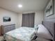 Bedroom features a TV, gray walls, and comfortable bedding at 7352 Oakmoss Loop, Davenport, FL 33837