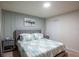 Bedroom with modern bedding and decor, light paint and recessed lighting at 7352 Oakmoss Loop, Davenport, FL 33837