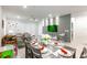 Elegant dining room with modern lighting, seamlessly connected to the living area for open-concept living at 7352 Oakmoss Loop, Davenport, FL 33837