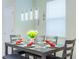 Elegant dining room with a modern chandelier, set table, and comfortable seating for a pleasant dining experience at 7352 Oakmoss Loop, Davenport, FL 33837