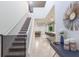 Open entryway with a staircase and views of the dining room, living room, and kitchen with a large island at 7352 Oakmoss Loop, Davenport, FL 33837
