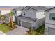 Charming two-story home with a grey brick driveway and manicured landscaping at 7352 Oakmoss Loop, Davenport, FL 33837