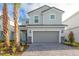 Charming two-story home features a gray color scheme, manicured landscaping and a two car garage at 7352 Oakmoss Loop, Davenport, FL 33837