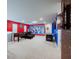 Recreational space features an air hockey table, foosball, comfy seating and superhero decor at 7352 Oakmoss Loop, Davenport, FL 33837