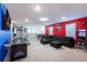 Spacious game room area featuring air hockey, foosball, and a large sectional sofa at 7352 Oakmoss Loop, Davenport, FL 33837