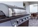 Close up of a stainless steel BBQ grill on the paved patio at 7352 Oakmoss Loop, Davenport, FL 33837