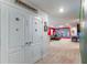 Hallway view leading to a finished basement with a foosball table, sofa, and superhero decor at 7352 Oakmoss Loop, Davenport, FL 33837