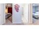 Hallway view of bedrooms and bathroom with neutral carpeting and decor at 7352 Oakmoss Loop, Davenport, FL 33837