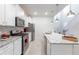 Well-equipped kitchen features white cabinets, granite countertops, stainless steel appliances, and an open layout at 7352 Oakmoss Loop, Davenport, FL 33837