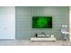 Living room with a stylish accent wall, a sleek TV, and modern decor for a comfortable and inviting space at 7352 Oakmoss Loop, Davenport, FL 33837