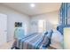 Comfortable bedroom featuring a stylish bed, soft lighting, and access to an en-suite bathroom for added privacy at 7352 Oakmoss Loop, Davenport, FL 33837