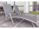 Two gray lounge chairs sit on the paved patio near a windowed lanai at 7352 Oakmoss Loop, Davenport, FL 33837