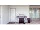 View of a stainless steel BBQ grill on the paved patio with a trash can at 7352 Oakmoss Loop, Davenport, FL 33837