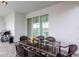 Outdoor patio with glass table, chairs, grill and view of sparkling pool at 7352 Oakmoss Loop, Davenport, FL 33837