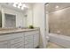 Bathroom featuring a double sink vanity, granite countertops and a bathtub shower at 7577 Oak Spring Ln, Davenport, FL 33837