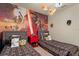 Bright ' bedroom with two twin beds and a vibrant Star Wars themed mural at 7577 Oak Spring Ln, Davenport, FL 33837