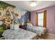Delightful ' bedroom with two beds and a whimsical Rapunzel-themed wall mural at 7577 Oak Spring Ln, Davenport, FL 33837