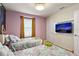 ' bedroom featuring two beds, a Rapunzel-themed mural, and a wall-mounted TV at 7577 Oak Spring Ln, Davenport, FL 33837