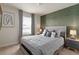 Relaxing bedroom featuring neutral gray tones, decorative pillows and artwork at 7577 Oak Spring Ln, Davenport, FL 33837