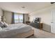 Relaxing bedroom featuring a king-size bed, a view of the lake, and a home office at 7577 Oak Spring Ln, Davenport, FL 33837