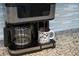 Close up of a modern coffee maker with a fresh brew in a Mickey Mouse mug at 7577 Oak Spring Ln, Davenport, FL 33837