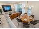 Dining room adjacent to living area features modern table and chairs set, and elegant chandelier at 7577 Oak Spring Ln, Davenport, FL 33837