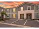 Inviting townhouse exterior with gray siding, blue shutters, and a manicured lawn at sunset at 7577 Oak Spring Ln, Davenport, FL 33837