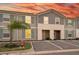 Charming two-story townhouse with gray siding, green shutters, and assigned parking at 7577 Oak Spring Ln, Davenport, FL 33837