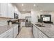 Bright kitchen featuring white cabinets, stainless steel appliances, and granite countertops at 7577 Oak Spring Ln, Davenport, FL 33837