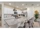 Modern kitchen with granite counters, stainless appliances, and pendant lighting at 7577 Oak Spring Ln, Davenport, FL 33837