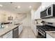 Modern kitchen island with granite counters, stainless appliances, and pendant lighting at 7577 Oak Spring Ln, Davenport, FL 33837