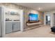 Convenient laundry area adjacent to the living space with a modern washer and dryer and shelf at 7577 Oak Spring Ln, Davenport, FL 33837