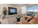 Cozy living room with stylish furniture, mounted television, and patio access at 7577 Oak Spring Ln, Davenport, FL 33837