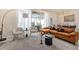 Open living room with comfortable seating area, dining room visible, and access to the outdoor patio at 7577 Oak Spring Ln, Davenport, FL 33837