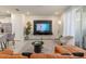 Cozy living area with TV set, plant, and white seating, open to the kitchen at 7577 Oak Spring Ln, Davenport, FL 33837