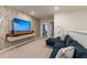 Upstairs living area featuring a large, mounted TV and a comfortable sectional sofa at 7577 Oak Spring Ln, Davenport, FL 33837
