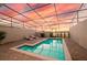 Beautiful screened pool with lounge chairs, grill, and sunset views at 7577 Oak Spring Ln, Davenport, FL 33837