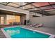 Inviting pool area with an outdoor kitchen and lounge chairs, perfect for entertaining at 7577 Oak Spring Ln, Davenport, FL 33837