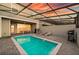 Backyard pool with patio seating, grill, and lush landscaping at 7577 Oak Spring Ln, Davenport, FL 33837
