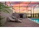Relaxing pool area with lounge chairs, grill and beautiful scenery; ideal outdoor living space at 7577 Oak Spring Ln, Davenport, FL 33837