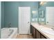 Bathroom with a double vanity, bathtub, and a door to the water closet at 805 Gordonia Ct, Deland, FL 32724