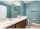 Bathroom featuring a double vanity and shower with glass door at 805 Gordonia Ct, Deland, FL 32724
