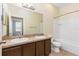 Bathroom with double sink vanity, tile floors, and combined tub/shower at 805 Gordonia Ct, Deland, FL 32724