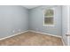 Simple bedroom with carpet, window, and blue walls at 805 Gordonia Ct, Deland, FL 32724