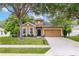 Charming single-Gathering home with a well-manicured lawn, beautiful trees, and a welcoming front door at 805 Gordonia Ct, Deland, FL 32724